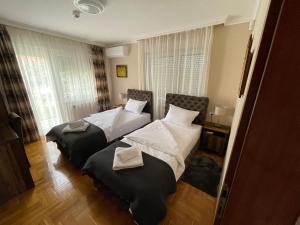 a bedroom with two beds in a room at Vila Jovanovic in Barajevo