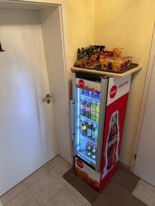 a small refrigerator with drinks inside of it at Haus Hotel & Pension am Birnengarten in Magdeburg