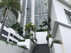 a stairway in a city with tall buildings at Luxxe interior design condo @ Novotel Suites Manila - Acqua in Manila