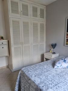 a bedroom with a bed and a large white closet at Esmeralda67 Tamarindo in Bayahibe +34 photos