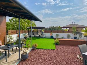 a backyard with a playground with a swing at טורקיז in Sede Neẖemya