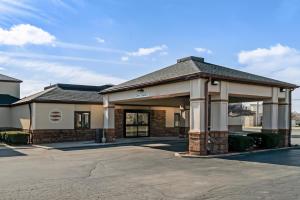 a large building with a parking lot at Comfort Inn East in Oregon