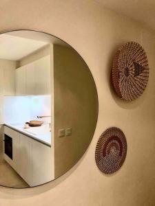 a mirror on the wall of a kitchen with a counter at Appartement 2 chambres COULEUR DUNE, piscine, parking gratuit in Le Touquet-Paris-Plage +23 photos