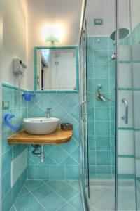 a bathroom with a sink and a shower at Sardinia Green Park Country Lodge in Olbia