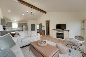 a living room with a white couch and a fireplace at Branson West Retreat - 2 Mi to Silver Dollar City! in Branson West