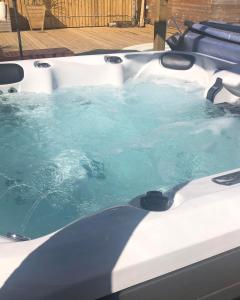 a jacuzzi tub with blue water in it at The Purple Tree Guest House in Torquay
