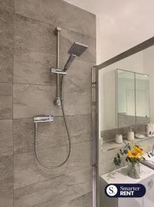 a shower in a bathroom with a sink at High Wycombe - 2 Bedroom House in Buckinghamshire