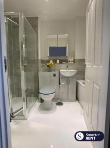 a bathroom with a toilet and a sink and a shower at High Wycombe - 2 Bedroom House in Buckinghamshire