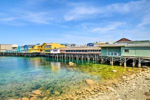 a group of houses on the water near a dock at Cozy Monterey Apartment - Walk to Wharf and Dtwn! in Monterey