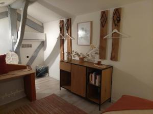 a living room with a book shelf in a room at Gite Marigot in Bazincourt-sur-Saulx