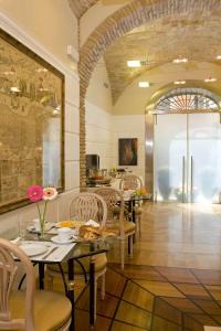 
a dining area with tables, chairs, and tables at Duca d'Alba Hotel - Chateaux & Hotels Collection in Rome
