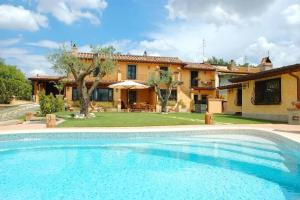 a large swimming pool in front of a house at Cosy penthouse loft with stunning view in Rome