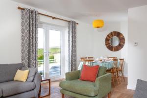a living room with a couch and chairs and a table at Endymion in Porthtowan