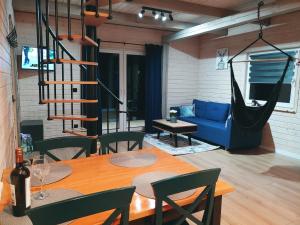 a living room with a table and a blue couch at Leśny Reset in Mrągowo