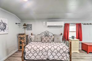 a bedroom with a bed and a red table at Cottage with Patio and Shared Waterfront Perks! in New Bern