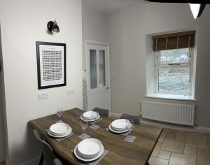 a dining room with a wooden table and a window at 1 The Croft in Cockermouth +9 photos
