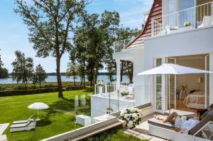 a house with a view of the water at Villa Contessa - Luxury Spa Hotels in Bad Saarow