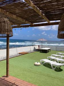 a group of chairs and an umbrella on the beach at Callao home in Moya