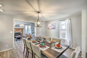 a dining room with a long table and chairs at Charming Eugene Home with Fire Pit 8 Mi to UO! in Eugene