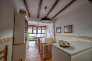 a kitchen with a table and a dining room at Casa rural collao de lobo in Serradilla +12 photos