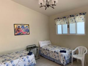 a bedroom with two beds and a window at Hotel y Restaurante Rincón Familiar in La Libertad +42 photos