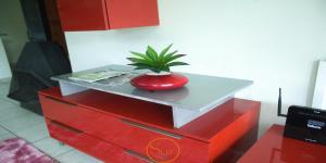 a red dresser with a potted plant on top of it at Slee Guest House in Howick