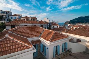 a view of roofs of houses in a town at Avli Townhouse in Panormos Skopelos