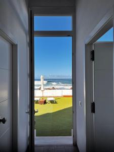 an open door with a view of the ocean at Callao home in Moya