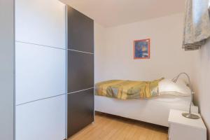 a small bedroom with a bed and a closet at Vita Garden Apartment 85 m2 Private Entrance & 100 m2 Terrace in Pula