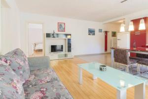 a living room with a couch and a table at Vita Garden Apartment 85 m2 Private Entrance & 100 m2 Terrace in Pula