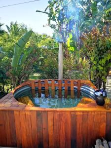 a small pool of water in a wooden tub at Santika Getaway Cottage Stellenbosch in Stellenbosch