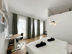 a bedroom with two beds and a desk in it at Plein Coeur de la Vieille Ville de Sion in Sion