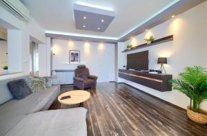 a living room with a couch and a table at Luxury apartments Vanessa, Njivice in Njivice