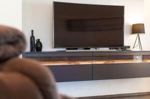 a person sitting in front of a flat screen tv at Luxury apartments Vanessa, Njivice in Njivice +30 photos