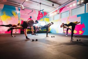 a group of people doing push ups on skateboards in a gym at evo Hotel in Salt Lake City