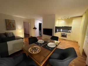 a living room with a table and chairs and a kitchen at Ferienwohnung Efibach 41 in Silenen