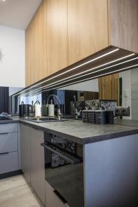 a kitchen with a sink and a stove top oven at APARTAMENT Welurowy in Kielce