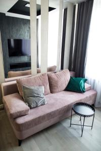 a couch with pillows on it in a living room at APARTAMENT Welurowy in Kielce