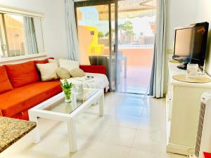 a living room with a couch and a coffee table at Boho Chic on the Beach by Deihu Experiences in Playa de las Americas