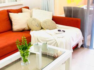 a living room with a couch and a table at Boho Chic on the Beach by Deihu Experiences in Playa de las Americas +28 photos