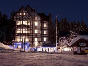 a large building with lights in the snow at night at Hakuba Sun Valley Hotel Annex - Vacation STAY 90337v in Iida