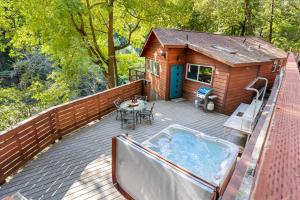 a hot tub on the deck of a cabin at Sydneys River Retreat in Guerneville