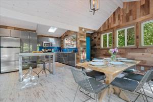 a kitchen and dining room with a table and chairs at Sydneys River Retreat in Guerneville