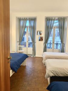 Zimmer mit 3 Betten und 2 Fenstern in der Unterkunft Barão 35 Guest House in Braga