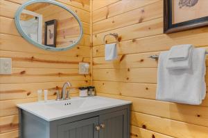 a bathroom with a sink and a mirror at Sydneys River Retreat in Guerneville +27 photos