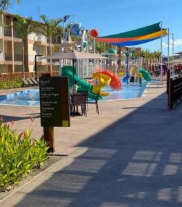 a playground with a water park with a slide at Apart Resort Beira Mar Mutá - PS in Porto Seguro