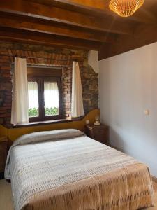 a bedroom with a large bed and two windows at Posada La Llosa de Viveda - Adults Only in Santillana del Mar