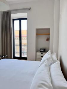 Łóżko lub łóżka w pokoju w obiekcie Imago Plus Hotel