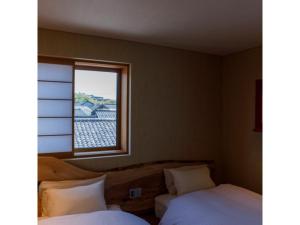 Postelja oz. postelje v sobi nastanitve Hotel Rashiku Kanazawa - Vacation STAY 49656v