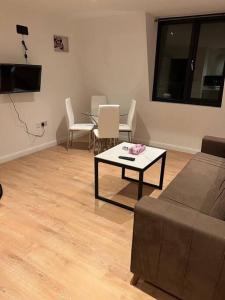 a living room with a couch and a table and chairs at 010- Lovely one bedroom in Ealing F6 in Ealing